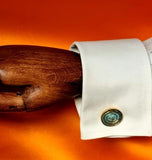 Round cufflinks in bronze with blue green patina. Shown on a cuff, to demonstrate their large size and sculpture appeal. Ideal as gifts and for special occasions.