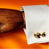 Sculptural bronze cufflinks shown in place. These hand made cufflinks are uniquely designed and make a real impression.