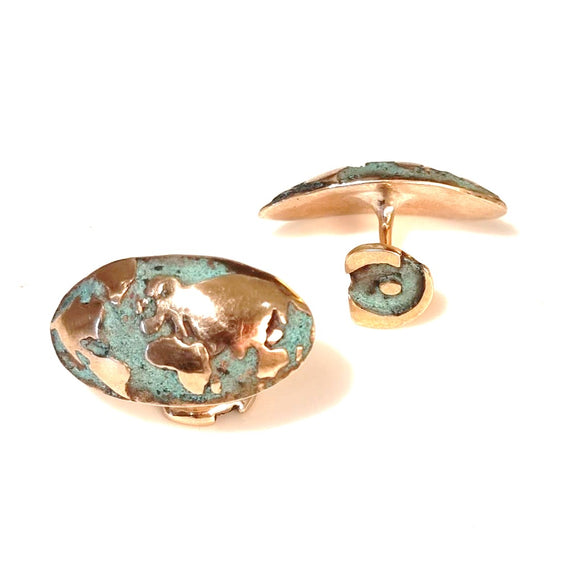 Pair of map of the world bronze cufflinks on a white background